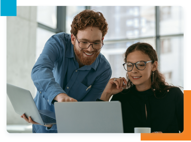 Office workers smiling and looking at laptop