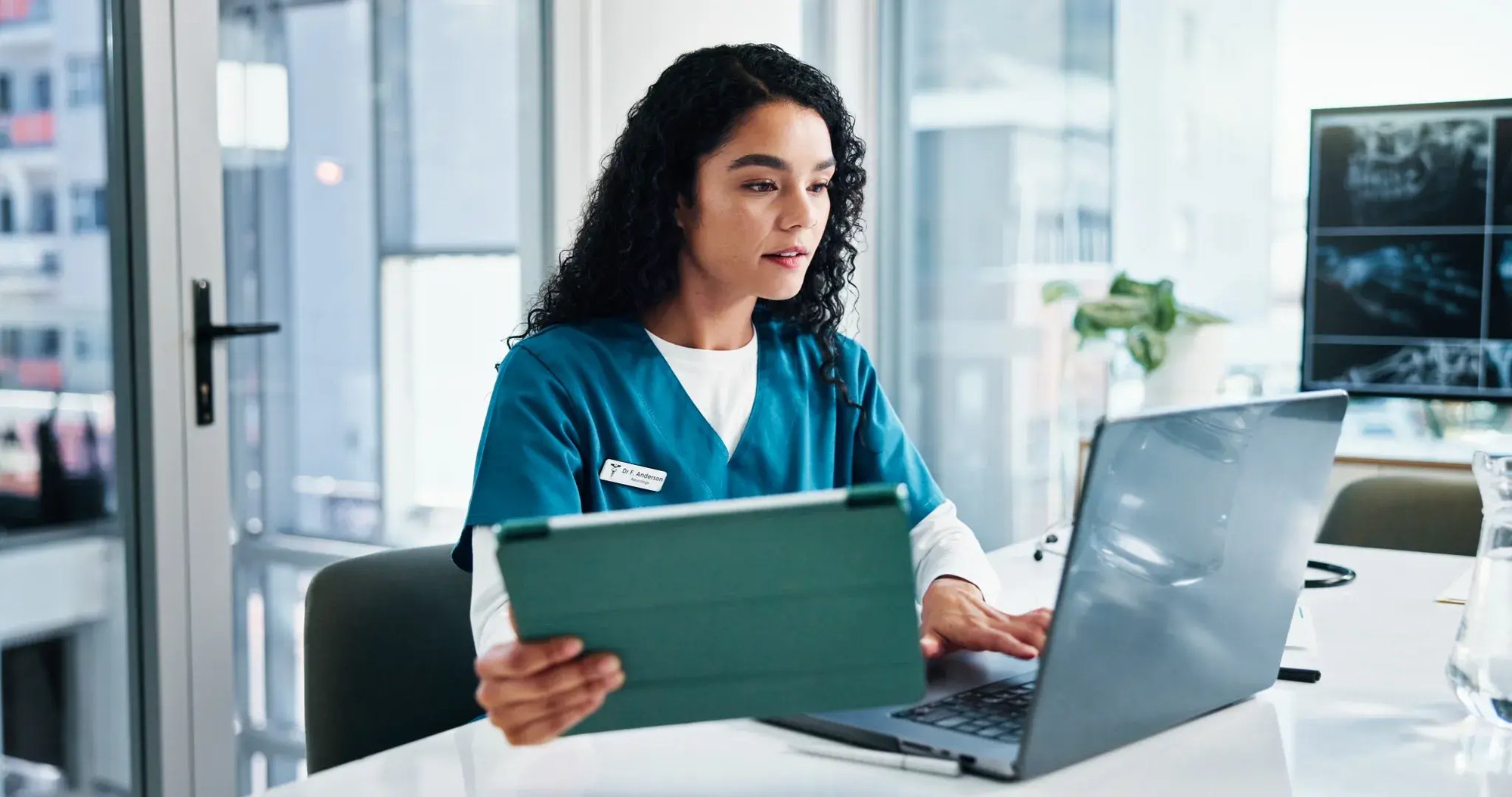 nurse on computer and tablet