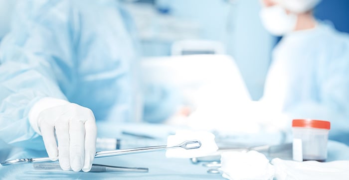 surgeon grabbing tools