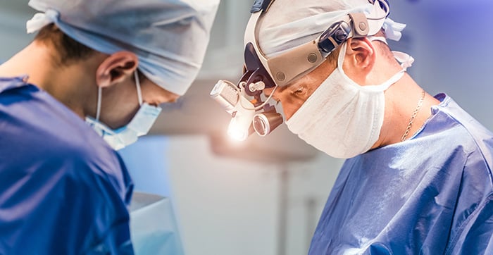 surgeons operating on patient